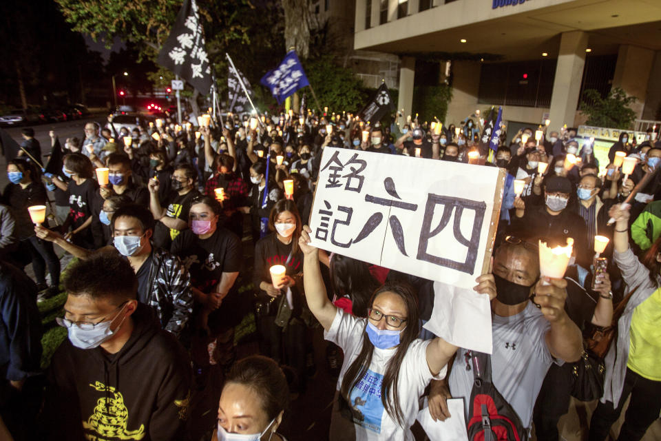 Participants attend a candlelight vigil outside the Chinese consulate general in Los Angeles on Friday, June 4, 2021, to mark the 32nd anniversary of the crackdown on the pro-democracy protests in Beijing's Tiananmen Square. (AP Photo/Ringo H.W. Chiu)