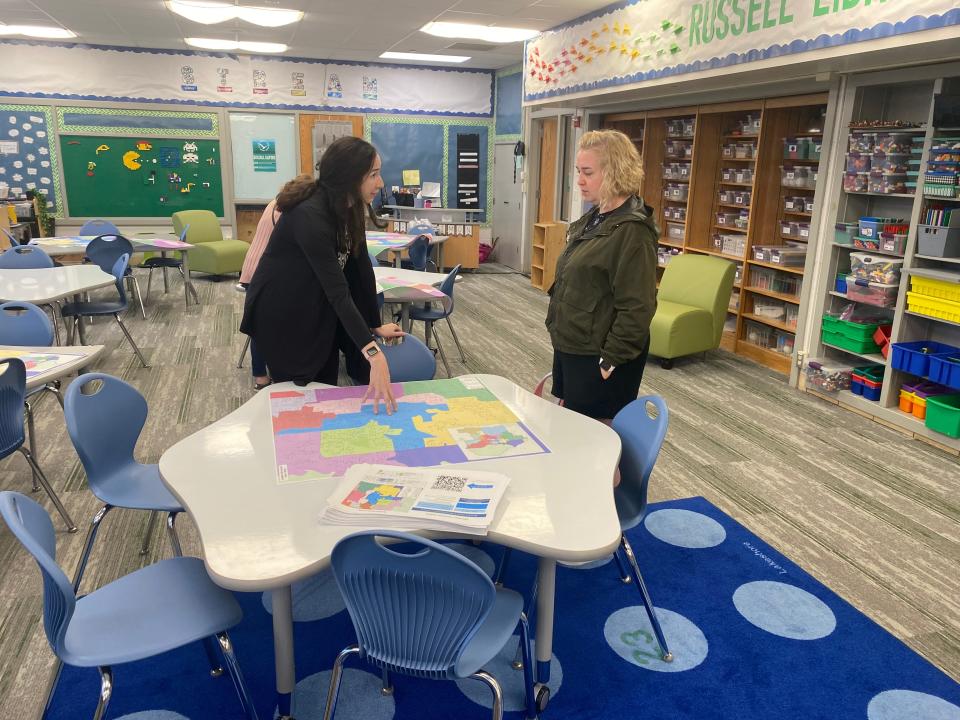 Karen Jackson, with Columbia Public Schools contractor Woolpert, on Monday talks with parent Sarah Whittier about options for boundary changes at Russell Boulevard Elementary School during an informational open house.