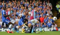 Chelsea's Eden Hazard has a shot on goal which is turned into his own net by Aston Villa's Antonio Luna (centre right)