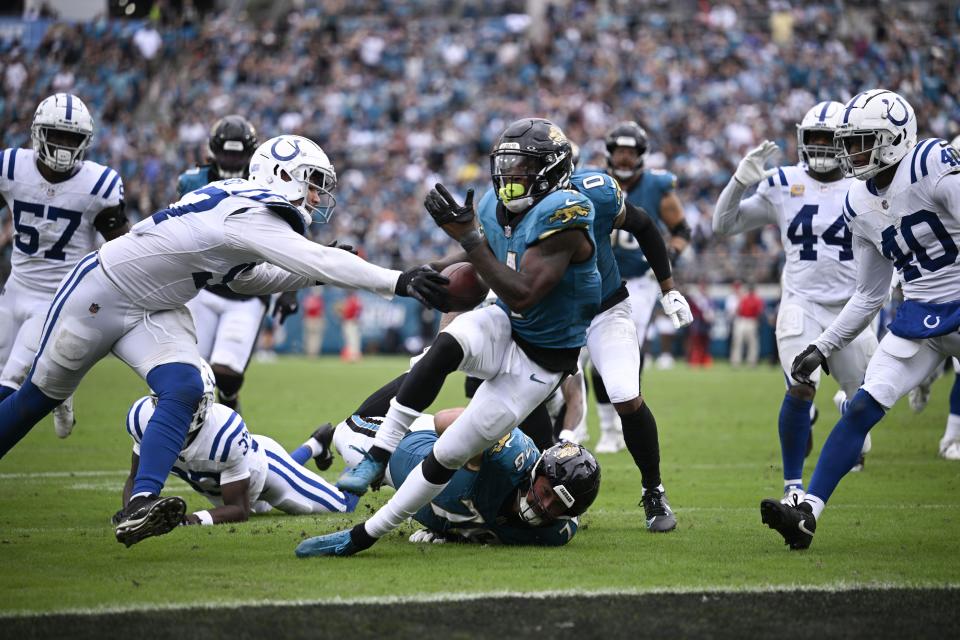 Jacksonville Jaguars running back Tank Bigsby (4) goes in for a touchdown during the second half of an NFL football game against the Indianapolis Colts, Sunday, Oct. 6, 2024, in Jacksonville, Fla. (AP Photo/Phelan M. Ebenhack)