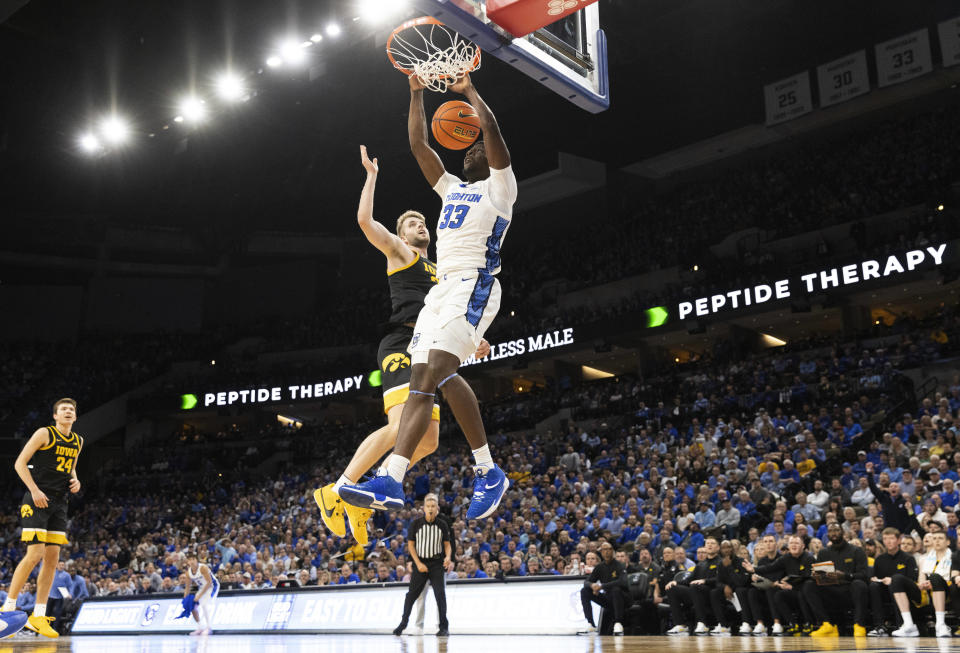 Creighton's Fredrick King, front, dunks against Iowa's Ben Krikke during the first half of an NCAA college basketball game Tuesday, Nov. 14, 2023, in Omaha, Neb. (AP Photo/Rebecca S. Gratz)