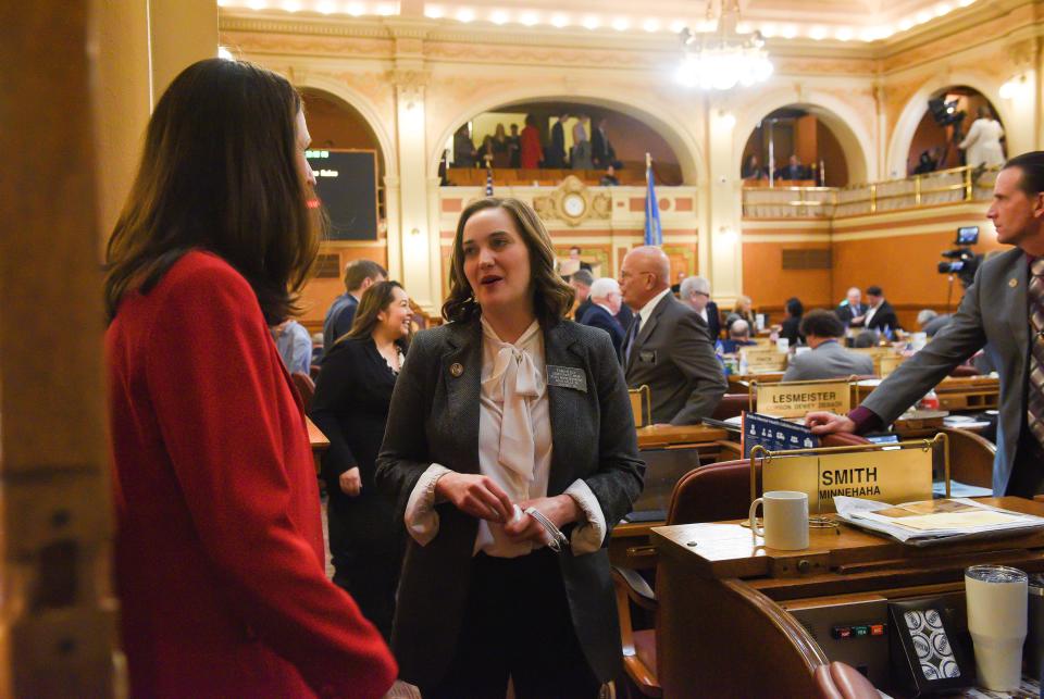 Rep. Erin Healy, Democratic whip, speaks with fellow legislators before the annual State of the State address in January 2020.