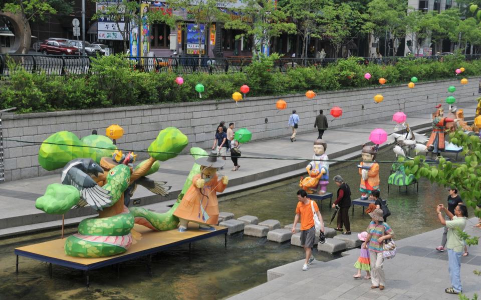 The Cheonggyecheon River flows from west to east through central Seoul.