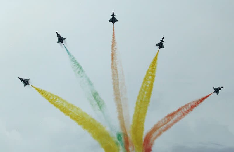 China's People's Liberation Army Air Force (PLAAF) Ba Yi aerobatics team perform an aerial display during a media preview of the Singapore Airshow in Singapore