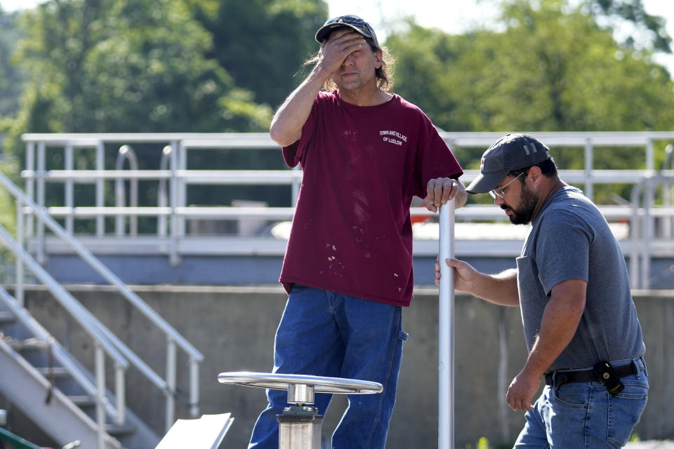 Joe Gaudiana, the Ludlow, Vt., chief water and sewer operator, left, pauses while surveying damage with Elijah Lemieux, of the Vermont Rural Water Association, at the wastewater treatment plant following July flooding, Wednesday, Aug. 2, 2023, in Ludlow. Across the U.S., municipal water systems and sewage treatment plants are at increasing risk of damage from floods and sea-level rise brought on in part or even wholly by climate change. The storm that walloped Ludlow especially hard, damaging the picturesque ski town’s system for cleaning up sewage before it’s discharged into the Williams River. (AP Photo/Charles Krupa)