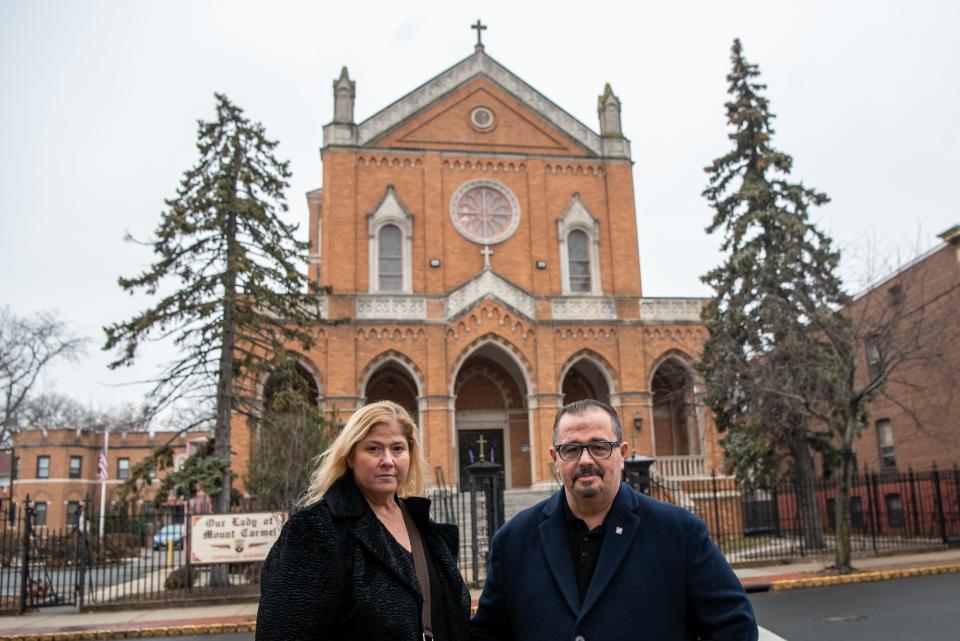 Siblings Marialena Marzullo and Raffaele Marzullo pose for a photo in front of Our Lady of Mount Carmel Church in Montclair on Saturday Dec.17, 2021. The Marzullo siblings look forward to the church offering Sunday masses again. 