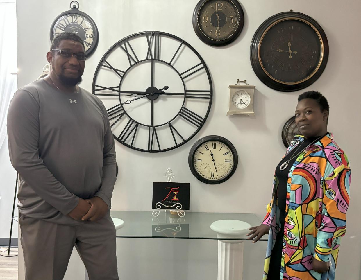 Sophia (right) and Willie Jefferson of Peoria display a Timeless Events Social Studio showpiece: a wall of clocks dedicated to Sophia's late father.