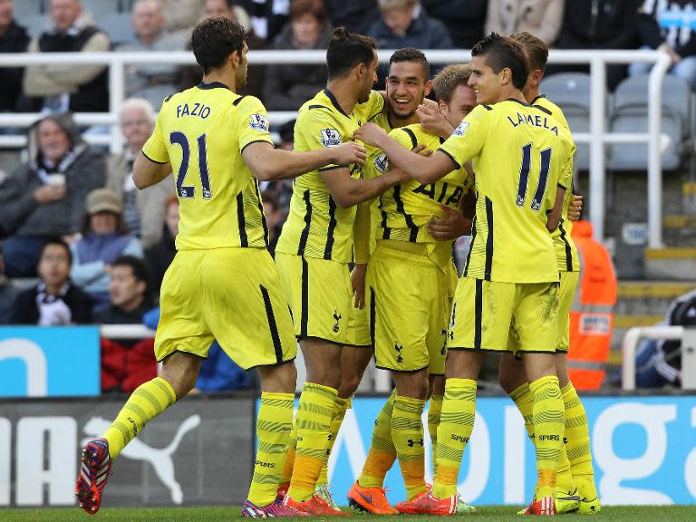 Tottenham Hotspur's midfielder Christian Eriksen (4-L) celebrates scoring their second goal with teammates during the English Premier League football match against Newcastle United on April 19, 2015