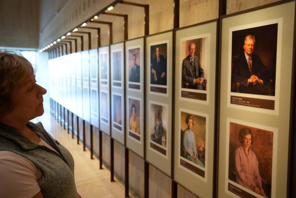 A woman from Louisville, Colorado, looks at a portrait of former President Jimmy Carter on Feb. 20, 2023 at the LBJ Presidential Library and Museum in Austin, Texas. The museum offered free admission in celebration of Presidents Day.