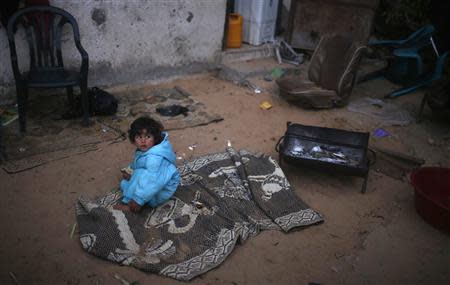 A Palestinian girl sits at her family's house in the northern Gaza Strip March 20, 2014. REUTERS/Mohammed Salem