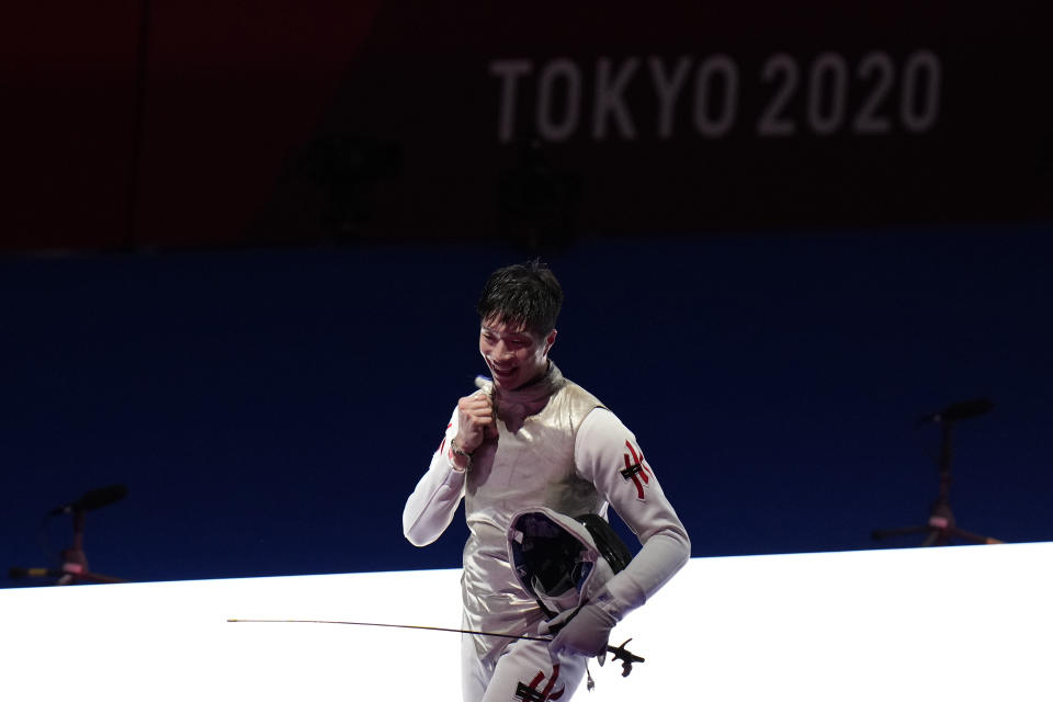 Ka Long Cheung of Hong Kong celebrates defeating Daniele Garozzo of Italy in the men's individual final Foil competition at the 2020 Summer Olympics, Monday, July 26, 2021, in Chiba, Japan. (AP Photo/Hassan Ammar)