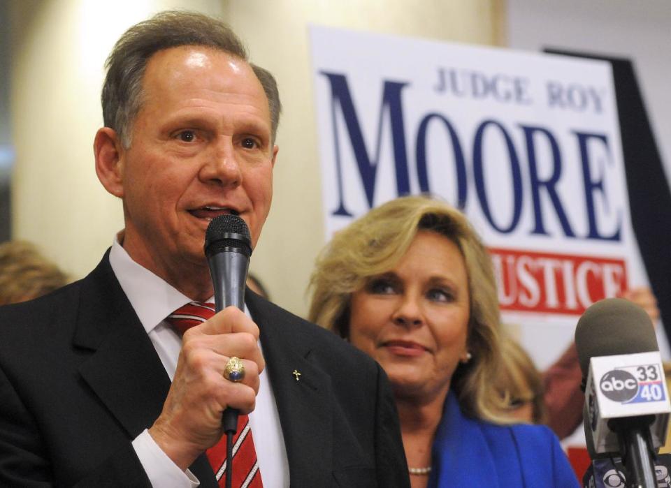 FILE - In this Tuesday, Nov. 6, 2012 file photo, Roy Moore, candidate for Alabama Supreme Court chief justice, speaks to the audience as wife Kayla looks on at his election party in Montgomery, Ala., on election night. Chief Justice Moore, known for fighting to display the Ten Commandments in a judicial building, has written to all 50 governors urging them to support a federal constitutional amendment defining marriage as between only a man and a woman. (AP Photo/David Bundy, File)