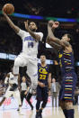 Orlando Magic's D.J. Augustin (14) drives to the basket against Cleveland Cavaliers' Jordan Clarkson (8) in the first half of an NBA basketball game, Friday, Dec. 6, 2019, in Cleveland. (AP Photo/Tony Dejak)