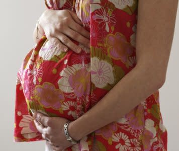 FILE PHOTO: A woman holds her stomach at the last stages of her pregnancy in Bordeaux April 28, 2010. REUTERS/Regis Duvignau