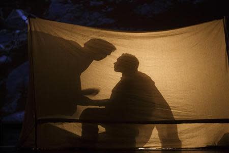 American tenor Tom Randle (Jack Twist) and Canadian bass-baritone Daniel Okulitch (Ennis del Mar), are silhouetted inside a tent as they perform during a dress rehearsal of the opera "Brokeback Mountain" at the Teatro Real in Madrid, January 24, 2014. REUTERS/Paul Hanna