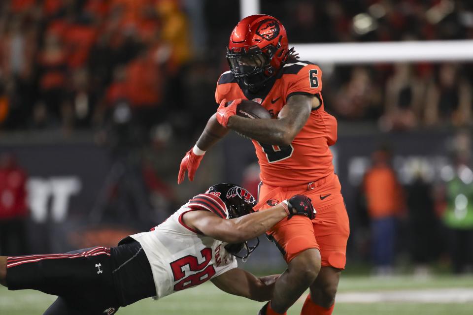 Oregon State running back Damien Martinez (6) is brought down by Utah safety Sione Vaki (28) during the second half of an NCAA college football game Friday, Sept. 29, 2023, in Corvallis, Ore. | Amanda Loman, Associated Press