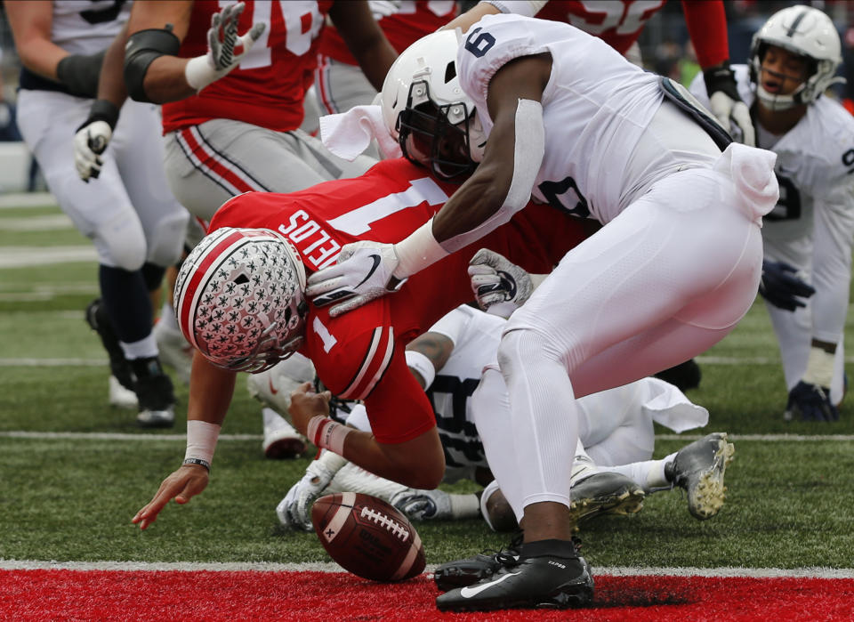 Penn State linebacker Cam Brown, right, causes Ohio State quarterback Justin Fields to fumble the ball before crossing the goal line during the first half of an NCAA college football game Saturday, Nov. 23, 2019, in Columbus, Ohio. Penn State recovered the ball for a touchback. (AP Photo/Jay LaPrete)