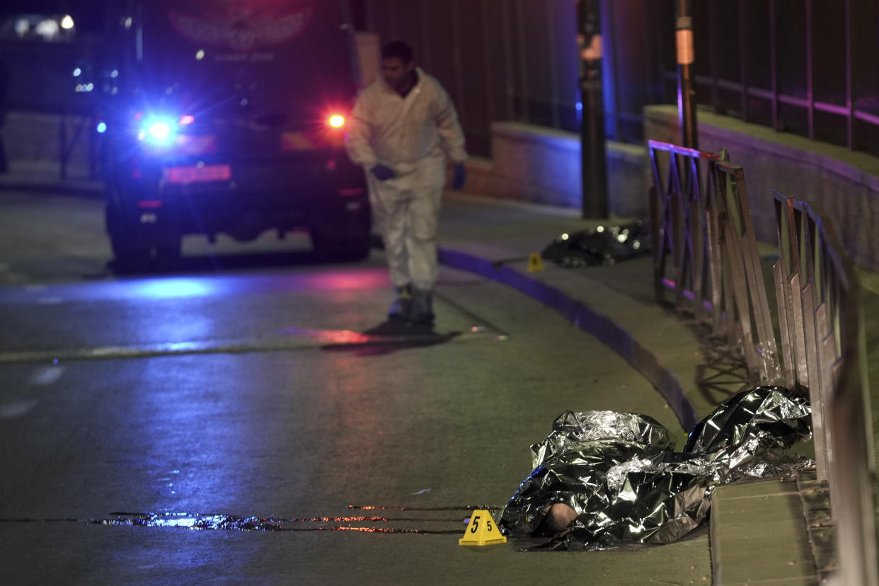 Victims of a shooting attack are covered near a synagogue in Jerusalem, Friday, Jan. 27, 2023. A Palestinian gunman opened fire outside an east Jerusalem synagogue Friday night, killing five people and wounding five others in one of the deadliest attacks on Israelis in years, medical officials said. The attack was halted when the gunman was shot by police. (AP Photo/Mahmoud Illean)