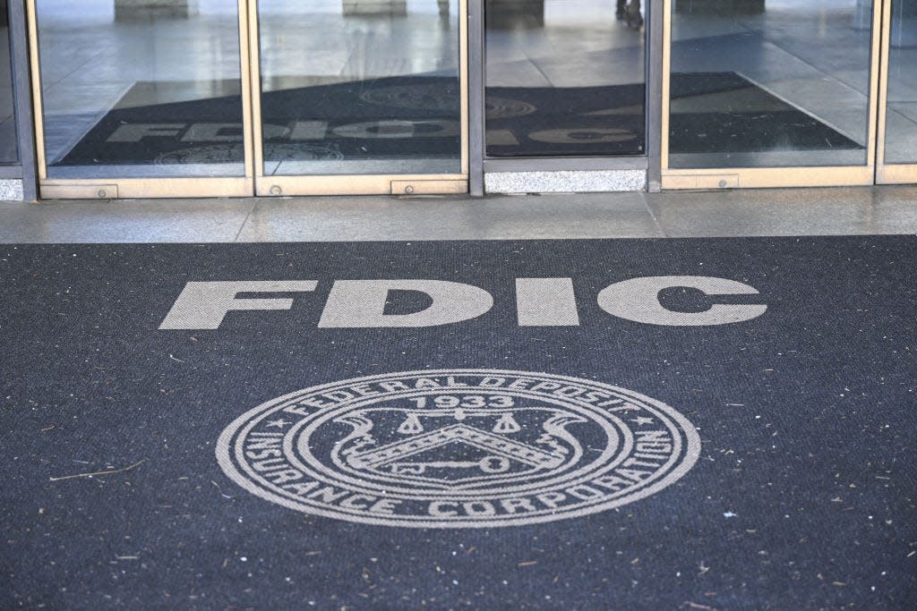 The entrance of a building with the FDIC logo on the floor.
