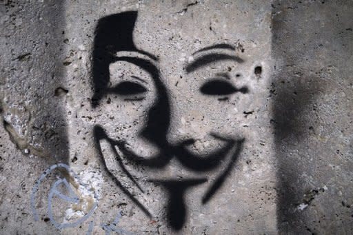 This file photo shows an image on a wall, representing Anonymous Guy Fawkes mask. On Wednesday, the Anonymous forum fired an opening shot by attacking the website of India's state-run telecom provider MTNL, pasting the logo of the group -- the mask of 17th century revolutionary Fawkes