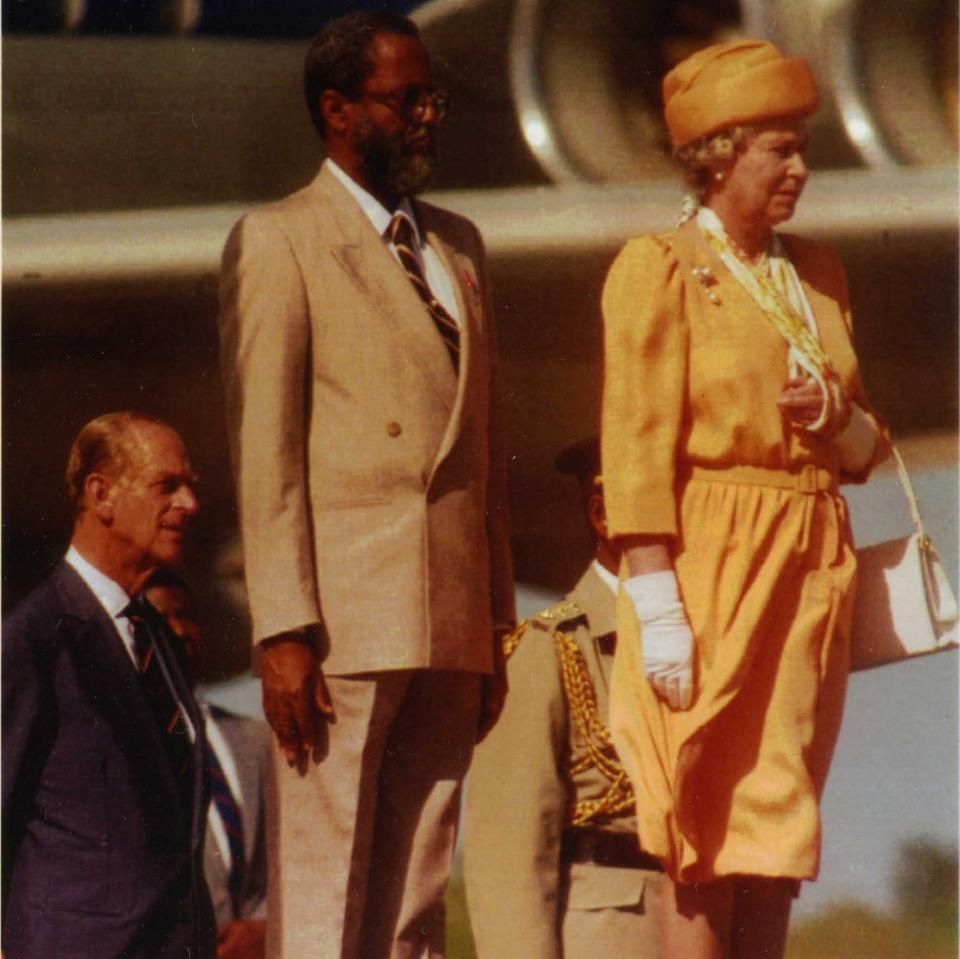 Queen Elizabeth II stands with Colville Norbert Young and her husband Prince Philip during a visit to Belize  - Credit: AP