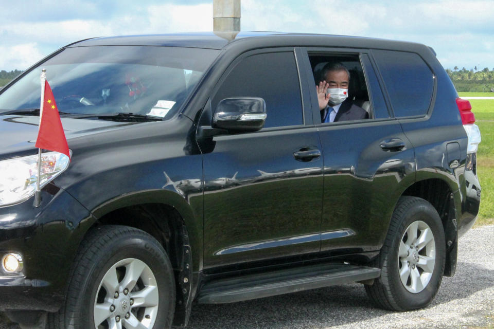 China's Foreign Minister Wang Yi waves from his car after he was welcomed by officials on his arrival in Nuku'alofa, Tonga, Tuesday, May 31, 2022. Wang and a 20-strong delegation are in Tonga as part of an eight-nation Pacific Islands tour that comes amid growing concerns about Beijing's military and financial ambitions in the South Pacific region. (Marian Kupu/ABC via AP)