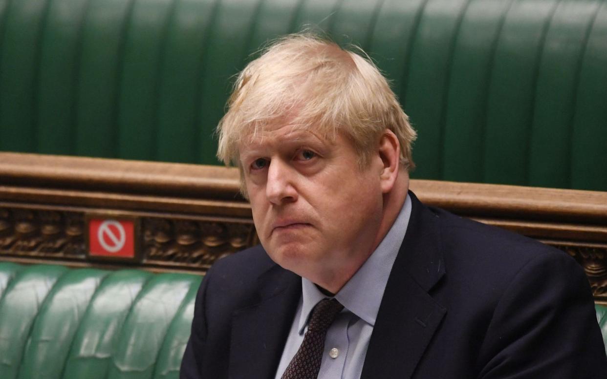 A handout photograph released by the UK Parliament shows Britain's Prime Minister Boris Johnson attending the weekly Prime Minister's Questions (PMQs) in the House of Commons in London  - JESSICA TAYLOR /AFP