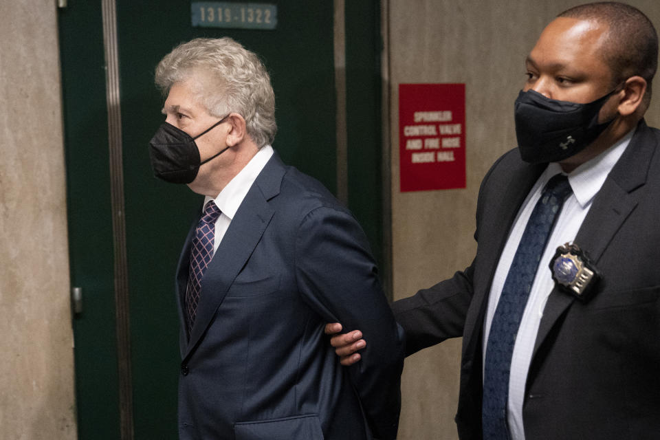 Glenn Horowitz, left, arrives to criminal court after being indicted for conspiracy involving handwritten notes for the Eagles album "Hotel California," Tuesday, July 12, 2022, in New York. (AP Photo/John Minchillo)