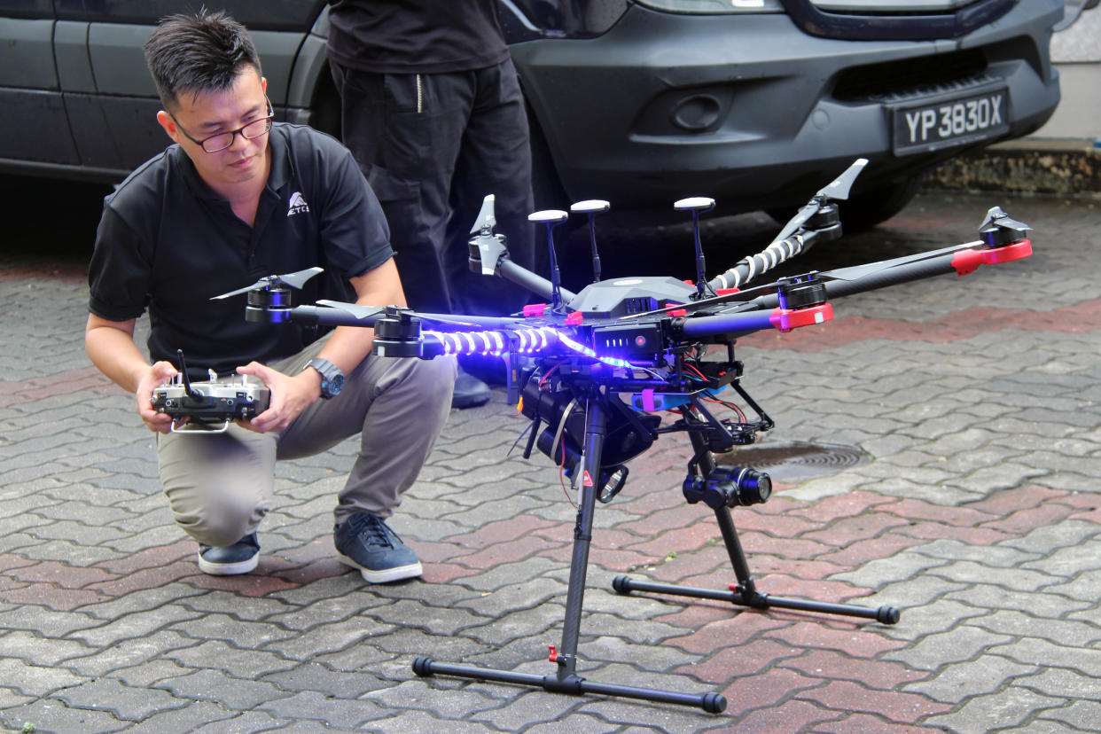 An AETOS staff member testing out a prototype Unmanned Aerial Vehicle which was deployed at Marina Bay Countdown 2018. (PHOTO: Wong Casandra / Yahoo News Singapore)