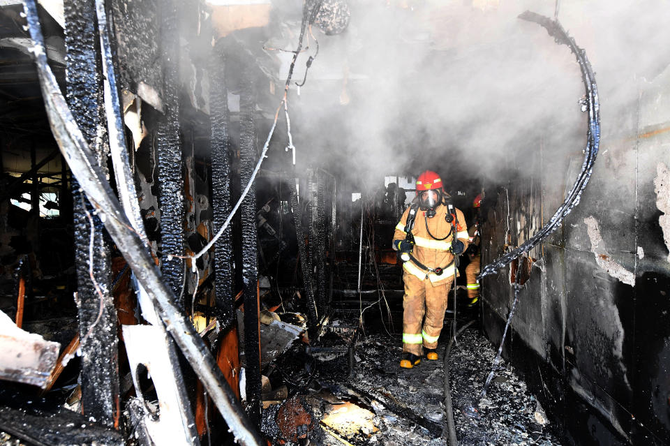 <p>Firefighters inspects a burnt hospital after a fire on January 26, 2018 in Miryang, South Korea. (Photo: Kyungnam Shinmun via Getty Images) </p>