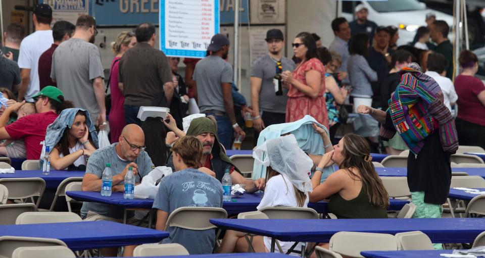 The beginning of rain doesn't deter some festival attendees during the second day of six-day Greek Festival at the Holy Trinity Greek Orthodox Church in Wilmington Tuesday, June 6, 2023. The festival runs through Saturday.