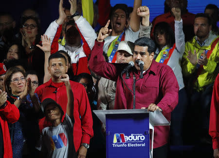 Venezuela's President Nicolas Maduro is surrounded by supporters as he speaks during a gathering after the results of the election were released, outside of the Miraflores Palace in Caracas, Venezuela, May 20, 2018. REUTERS/Carlos Garcia Rawlins