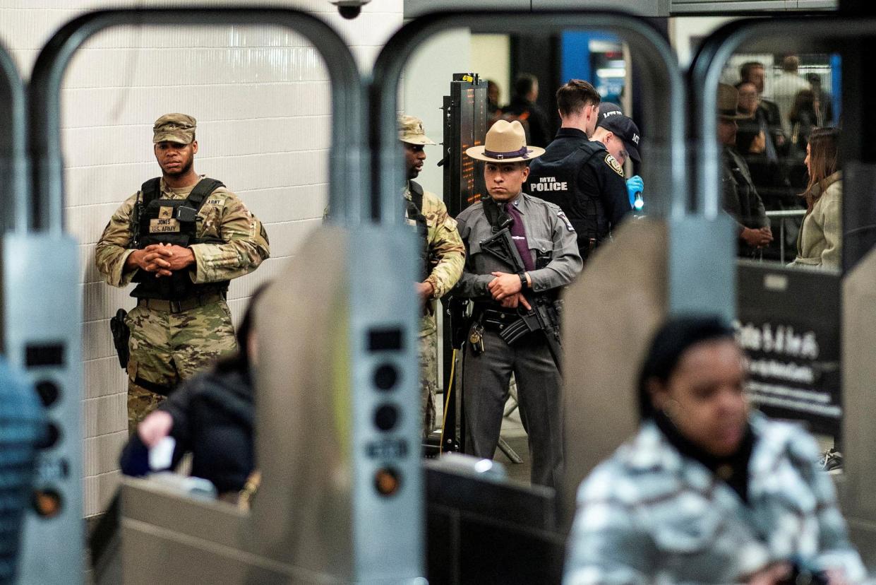 <span>A New York state police officer and members of the national guard in the New York City subway, on 7 March 2024.</span><span>Photograph: Eduardo Muñoz/Reuters</span>