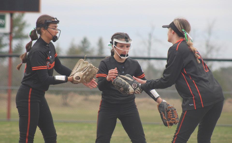 Cheboygan's Libby VanFleet (left), Presley Chamberlain (middle) and Amelia Johnson (right) celebrate getting an out against Rudyard during a game from the 2023 season.