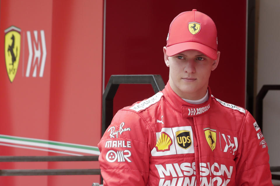 Mick Schumacher walks in the pit during his first F1 test for Ferrari at the Bahrain International Circuit in Sakhir, Bahrain, Tuesday, April 2, 2019. Mick Schumacher has moved closer to emulating his father Michael by driving a Ferrari Formula One car in an official test. Schumacher's father won seven F1 titles, five of those with Ferrari and holds the record for race wins with 91. (AP Photo/Hassan Ammar)