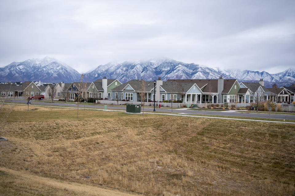 Homes line up against the backdrop of snow capped mountains in South Jordan, Utah, Sunday, Nov. 15, 2020. Founded by believers in what was then a small, fringe religion, Utah was then lost in the desolation of mountains and deserts, and viewed with suspicion by much of America. The insularity that resulted has been fading over the past few decades, but it's still a place intensely proud of its own distinctiveness. (AP Photo/Wong Maye-E)