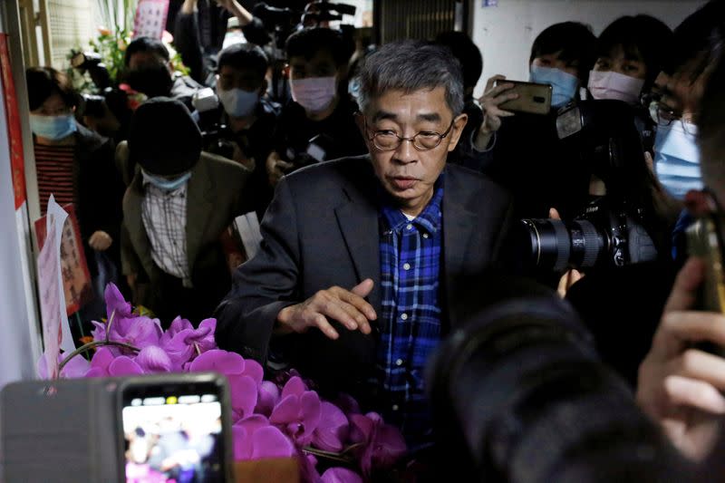 Lam Wing-Kee walks past the media at the opening day of his bookstore "Causeway Bay books" in Taipei