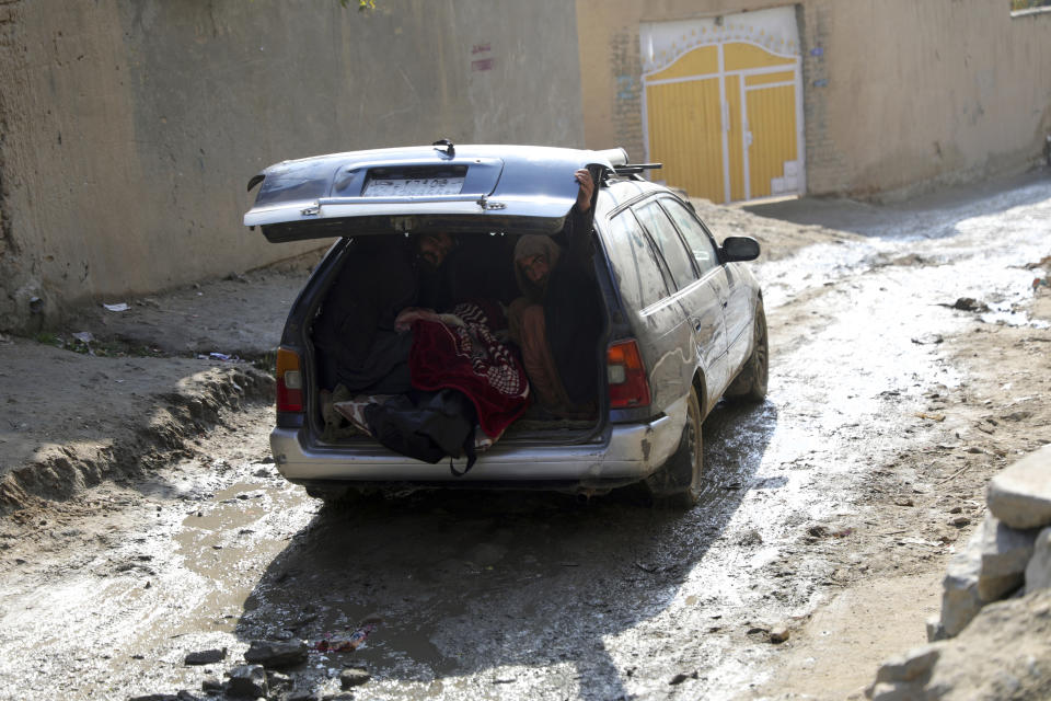 People carry the dead body of a relative who was killed by rockets attack in Kabul, Afghanistan, Saturday, Nov. 21, 2020. Mortar shells slammed into different parts of the Afghan capital on Saturday, killing several and wounding dozens of people, an official said. (AP Photo/Rahmat Gul)