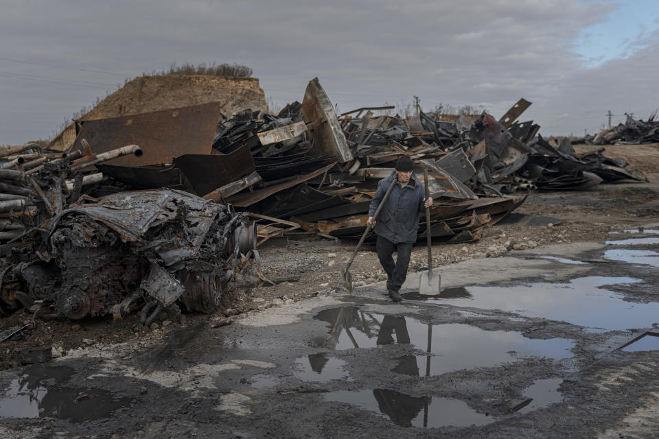 A worker walks at a fuel depot hit by Russian missile in the town of Kalynivka, about 30 kilometers (18 miles) southwest of Kyiv, Ukraine, Thursday, Oct. 27, 2022. Environmental damage caused by Ukraine's war is mounting in the 8-month-old conflict, and experts warn of long-term health consequences for the population. (AP Photo/Andrew Kravchenko)