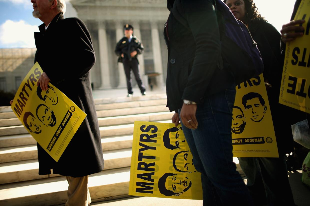  Holding signs with images of murdered Mississippi civil rights workers James Earl Chaney, Andrew Goodman, and Michael Schwerner, demonstrators rally in front of the US Supreme Court on 27 February, 2013 in Washington, DC. Previously sealed files on the 1964 killings of the three men have been released for public viewing. (Getty Images)