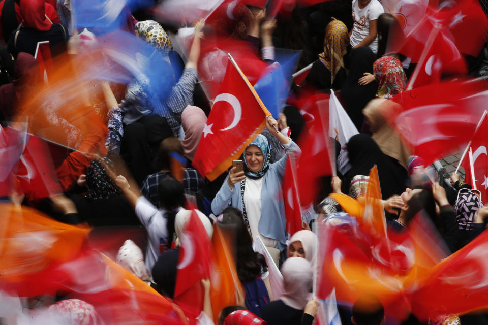 Supporters of Binali Yildirim, mayoral candidate for Istanbul from Turkey's ruling Justice and Development Party, AKP, attend a rally in Istanbul, Friday, June 21, 2019, ahead of June 23 re-run of mayoral elections. (AP Photo/Lefteris Pitarakis)