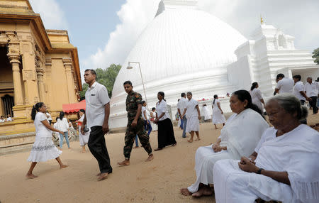 A Sri Lankan army soldier patrol inside the Kalaniya Buddhist temple during Vesak Day, commemorating the birth, enlightenment and death of Buddha, in Colombo, Sri Lanka May 18, 2019. REUTERS/Dinuka Liyanawatte