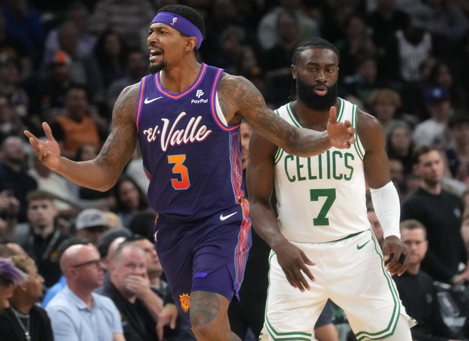 Phoenix Suns guard Bradley Beal (3) yells out to the referee for a foul call as Boston Celtics guard Jaylen Brown (7) defends at Footprint Center.