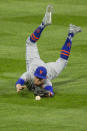 New York Mets center fielder Brandon Nimmo dives for a ball that went for a single by Philadelphia Phillies Didi Gregorius during the second inning of a baseball game, Monday, April 5, 2021, in Philadelphia. (AP Photo/Laurence Kesterson)