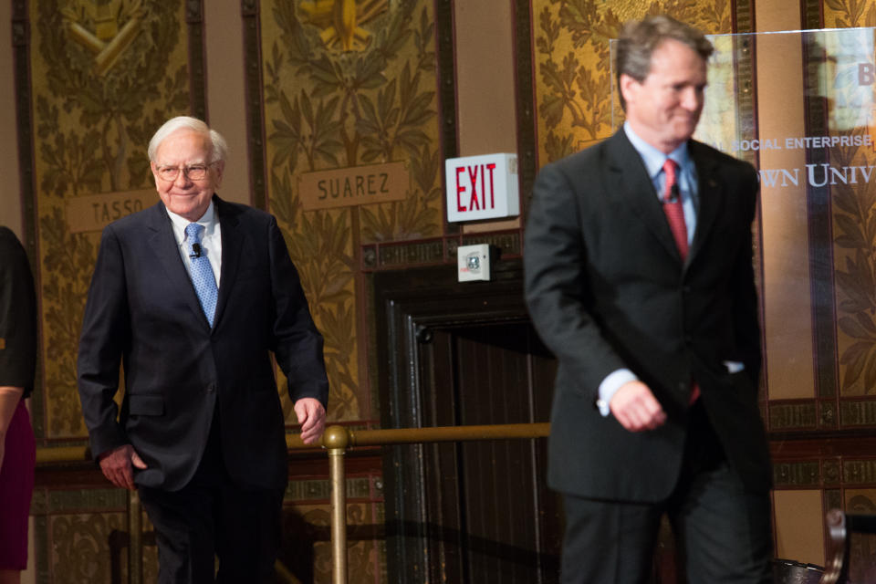 WASHINGTON, DC - SEPTEMBER Warren Buffett (L), chairman of the board and CEO of Berkshire Hathaway, walks on stage with Bank of America CEO Brian Moynihan, before speaking in Gaston Hall at Georgetown University, September 19, 2013 in Washington, DC. Buffett also took questions from Georgetown students. (Photo by Drew Angerer/Getty Images)