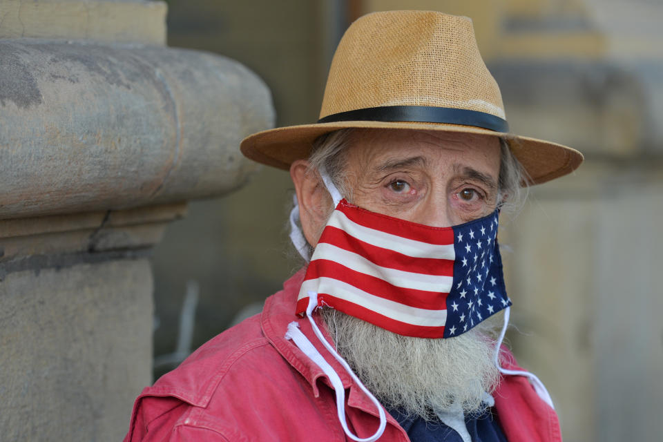 A local man wears a protective face mask with an American flag.
An open-air exhibition 'Polish Americans / American Poles' opened in Krakow's Planty Park, organized in cooperation with the Villa Decius Cultural Institute and the US Consulate in Krakow. Throughout October, while walking along the path from Poselska Street to Wawel, visitors and passersby can learn about the stories of famous Americans of Polish origin and their descendants.
On Thursday, October 21, 2020, in Krakow, Lesser Poland Voivodeship, Poland. (Photo by Artur Widak/NurPhoto via Getty Images)