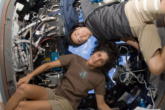 NASA astronaut Sunita Williams, Expedition 33 commander; and Japan Aerospace Exploration Agency astronaut Aki Hoshide, flight engineer, pose for a photo in the Cupola of the International Space Station. This image was taken Sept. 23, 2012.