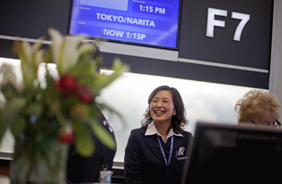 Gate agent Ayumi Buttrill, waits to board passengers on a plane to Tokyo, the first flight to leave out of the the new Maynard Holbrook Jackson Jr. International Terminal at Atlanta's airport on the first day it begins operating flights Wednesday, May 16, 2012, in Atlanta. (AP Photo/David Goldman)