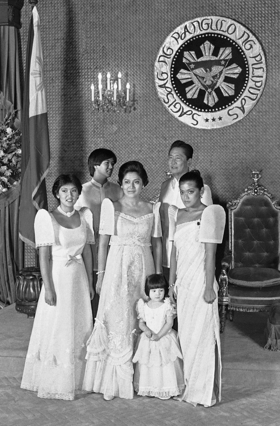 FILE - Philippine President Ferdinand Marcos, back right, and his wife Imelda Marcos, center, pose with their children and a niece, for an official portrait following Marcos inauguration on June 30, 1981, in Manila, Philippines. From left; Irene, Ferdinand Jr., Mrs. Marcos, Aimee, President Marcos, and Imee. (AP Photo/ Jeff Robbin, File)