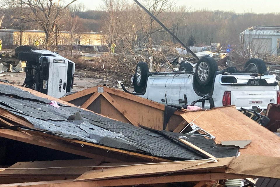 Up turned vehicles are seen next to damages structures after a tornado swept through Coralville, Iowa, Friday, March 31, 2023. (Ryan Foley / AP)